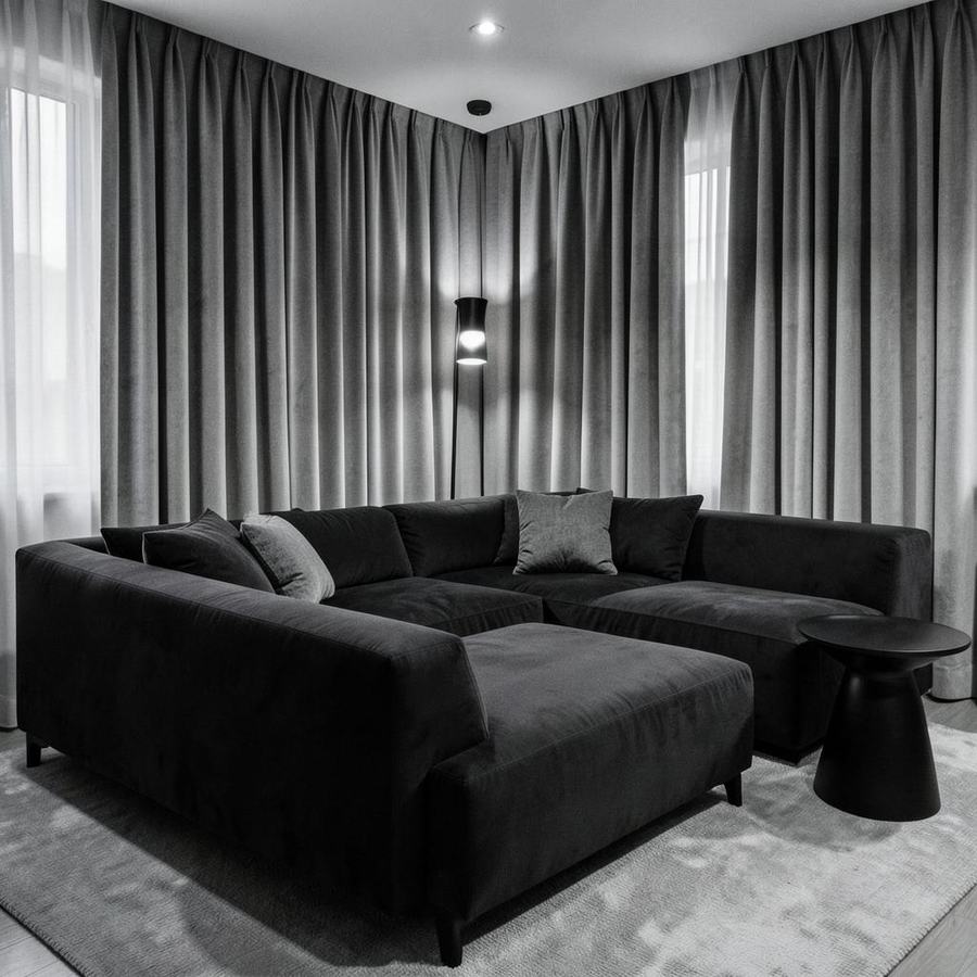 Media room with charcoal sectional and greige drapery